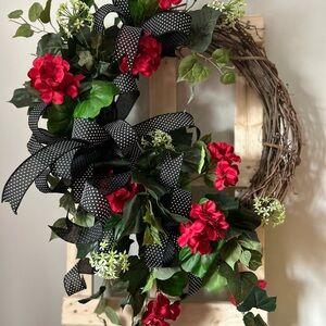 Festive Red Floral Wreath with Black Accents